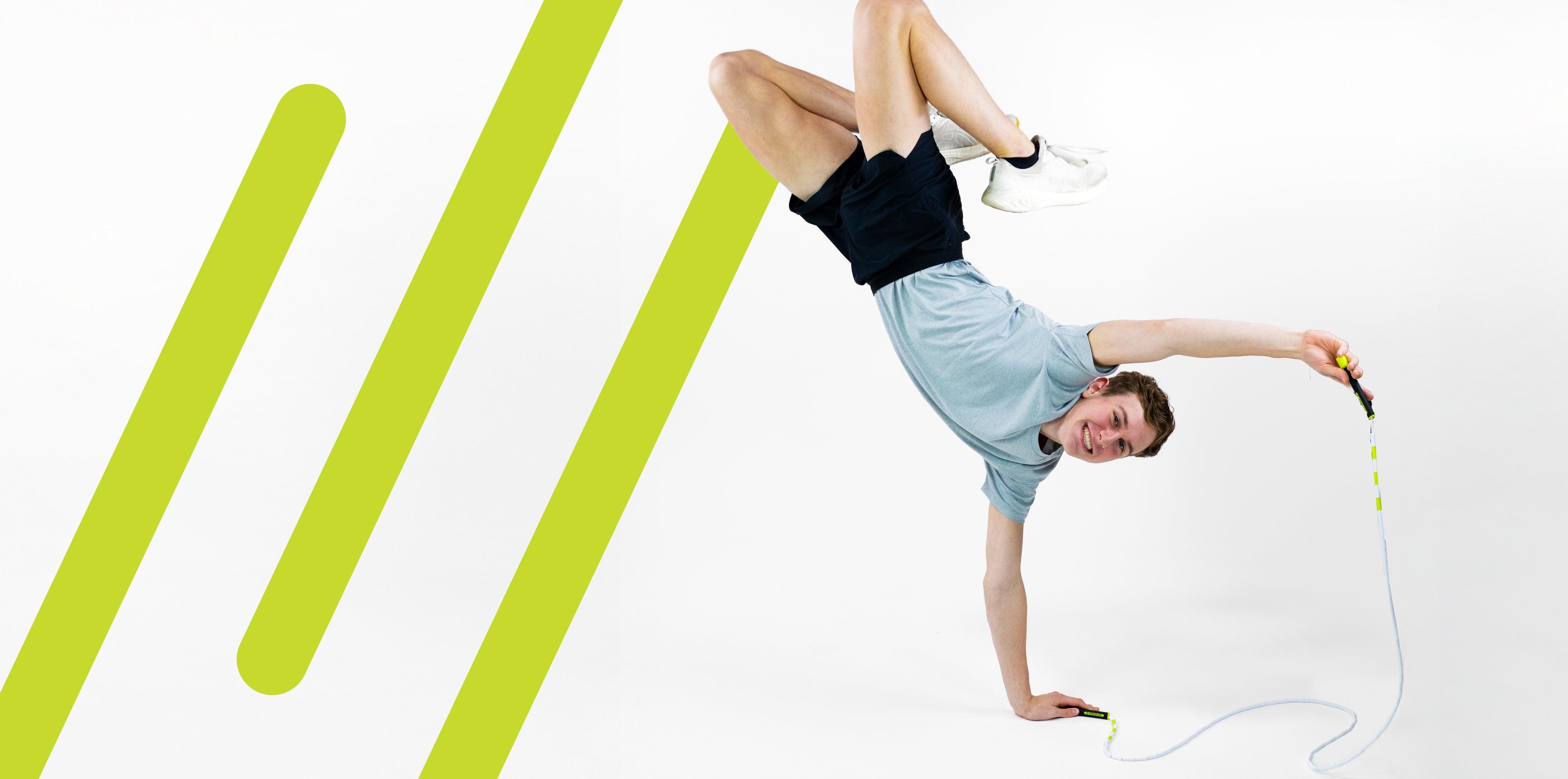 Man performing a jump rope trick with the jumprope.com logomark enlarged on a white background